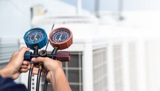 Technician is checking air conditioner ,measuring equipment for filling air conditioners , service and maintenance air conditioner .
