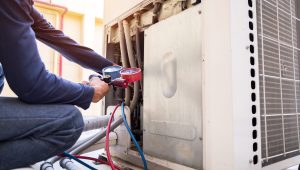 Technician is checking air conditioner ,measuring equipment for filling air conditioners.